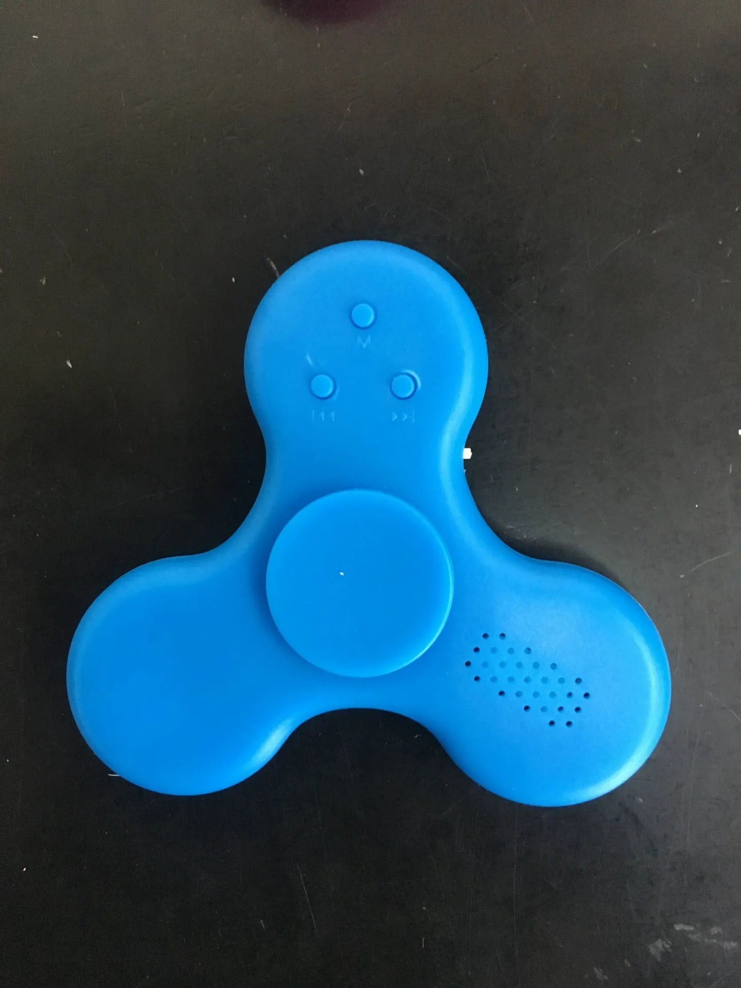 Compact white Bluetooth speaker and MP3 player designed as a fidget spinner toy.