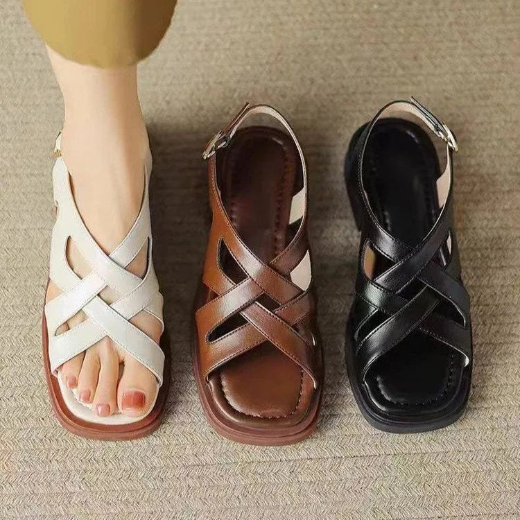 Women's glossy black patent leather beach sandals with a square toe and cross-belt design on a rubber sole.