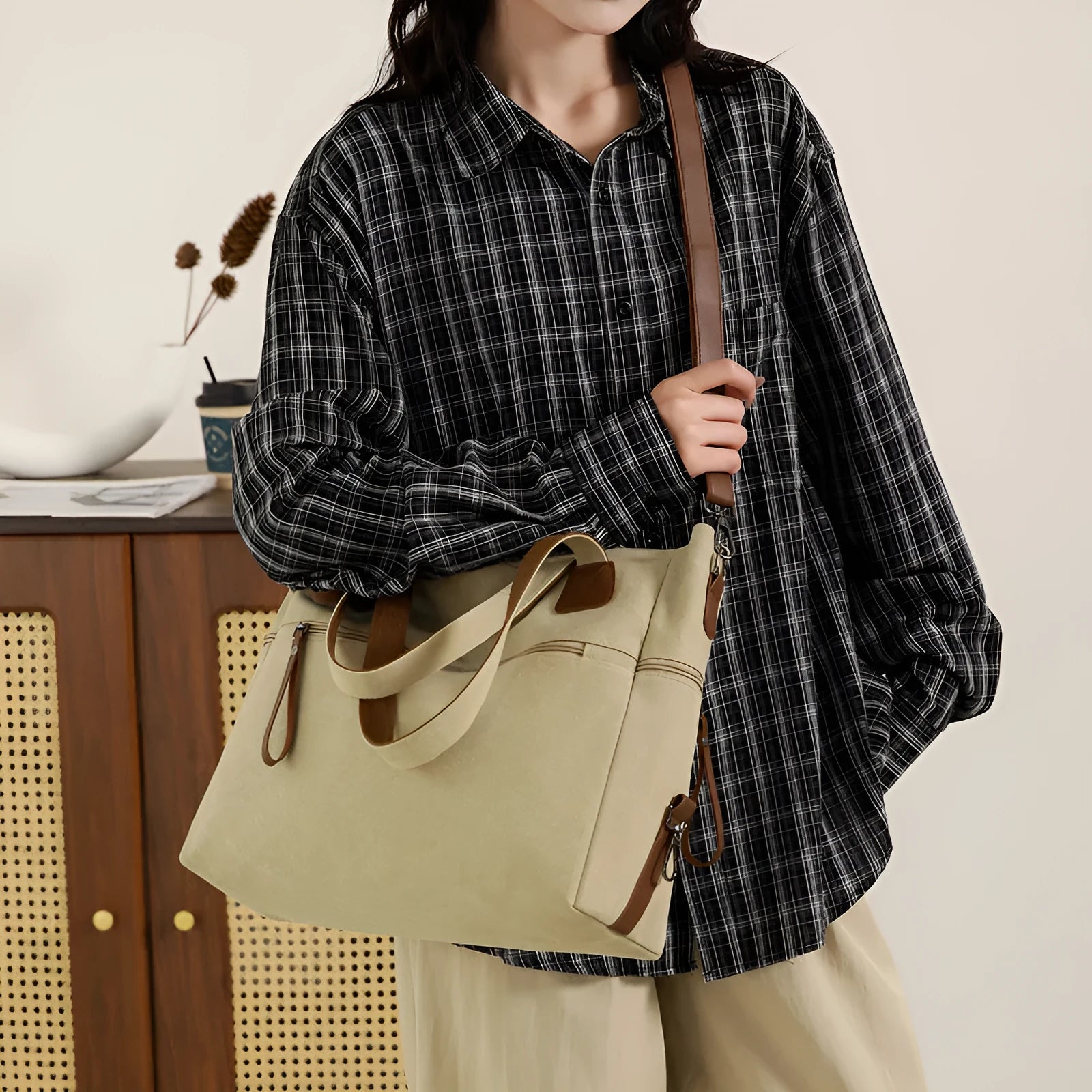 Large khaki retro canvas shoulder bag for women showing external sandwich pocket and internal organiser compartments.