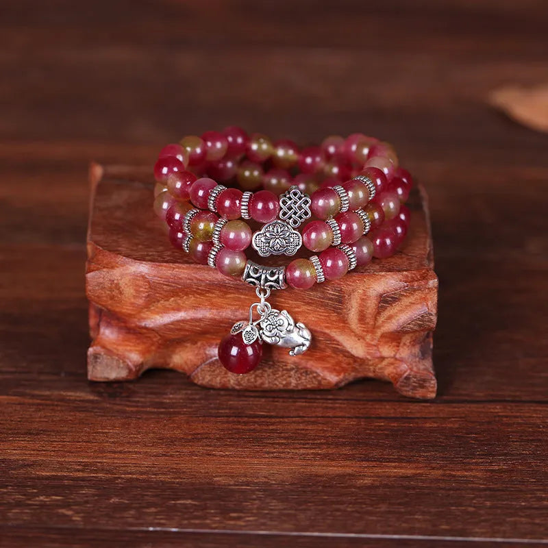 Watermelon crystal bracelet with Chinese knot closure and elephant bead design
