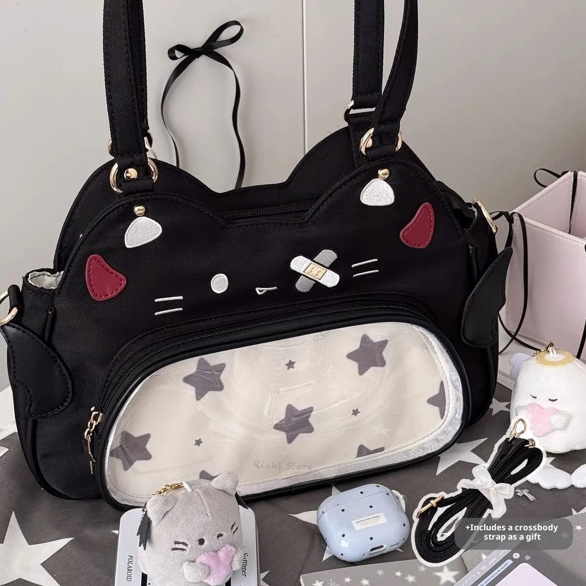 Horizontal cartoon owl pin PU crossbody bag in black, side view showing stitching and single strap