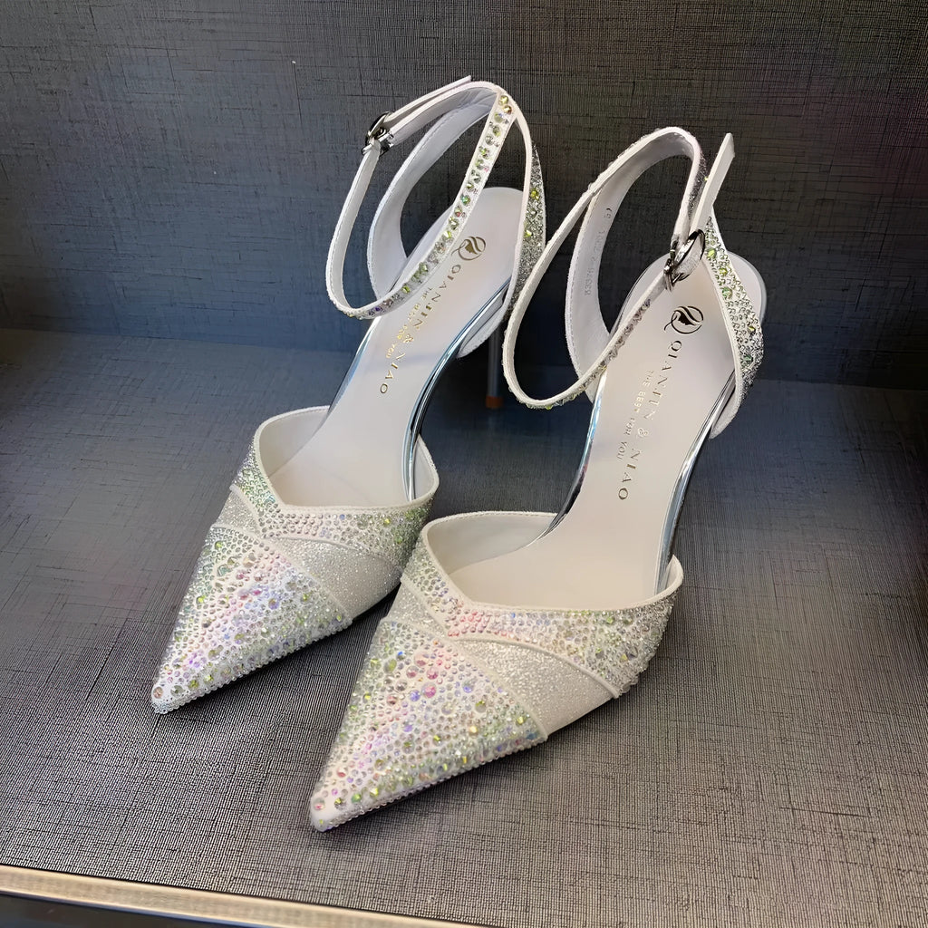 Black women's stiletto high heel shoe with a pointed toe and a bright red sole.