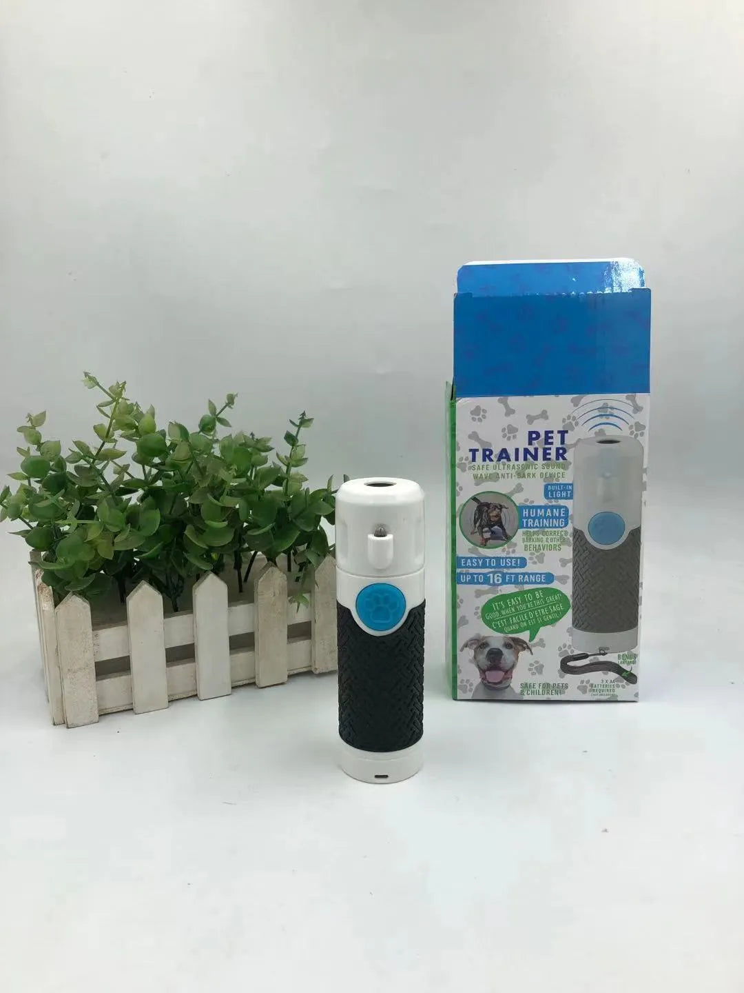 White ABS plastic handheld ultrasonic dog trainer device on a white background.
