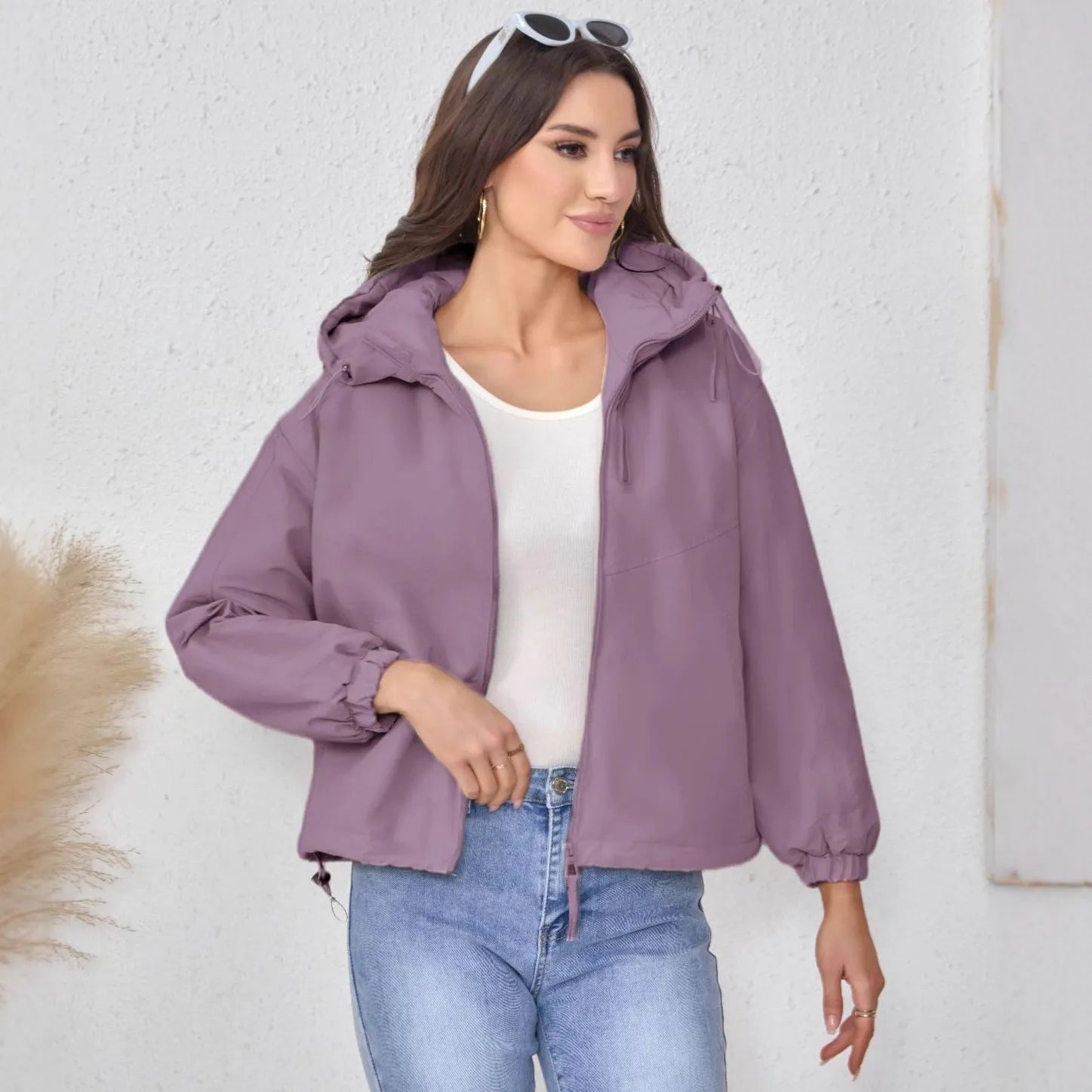 Women's grey loose-fit hooded polyester shell jacket with long sleeves.