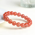 Natural South Cherry Red Agate bracelet with polished beads on an elasticated cord.