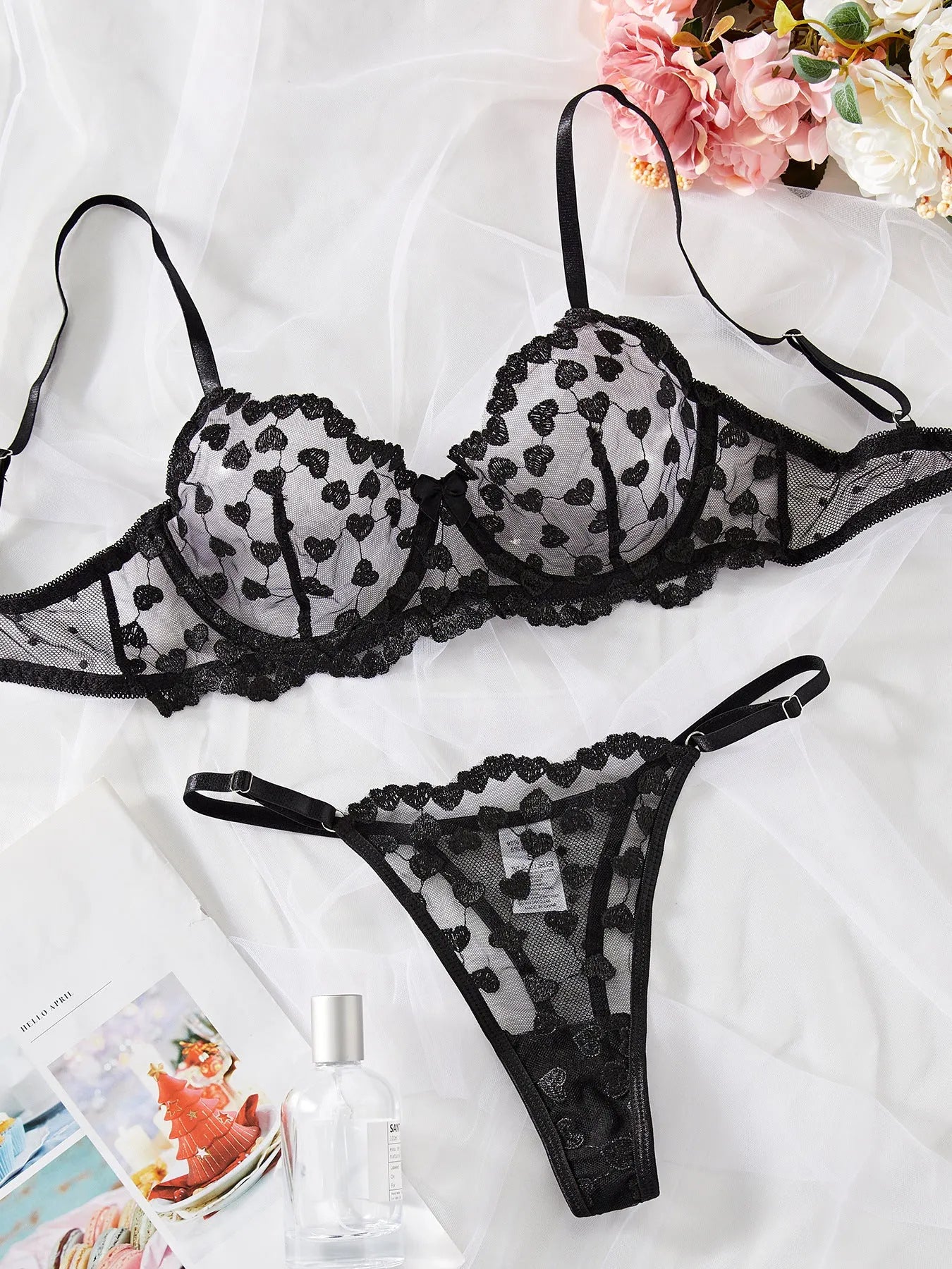 Women's black mesh two-piece suit with romantic multi-colour love print, showing V-neck top and straight-leg trousers