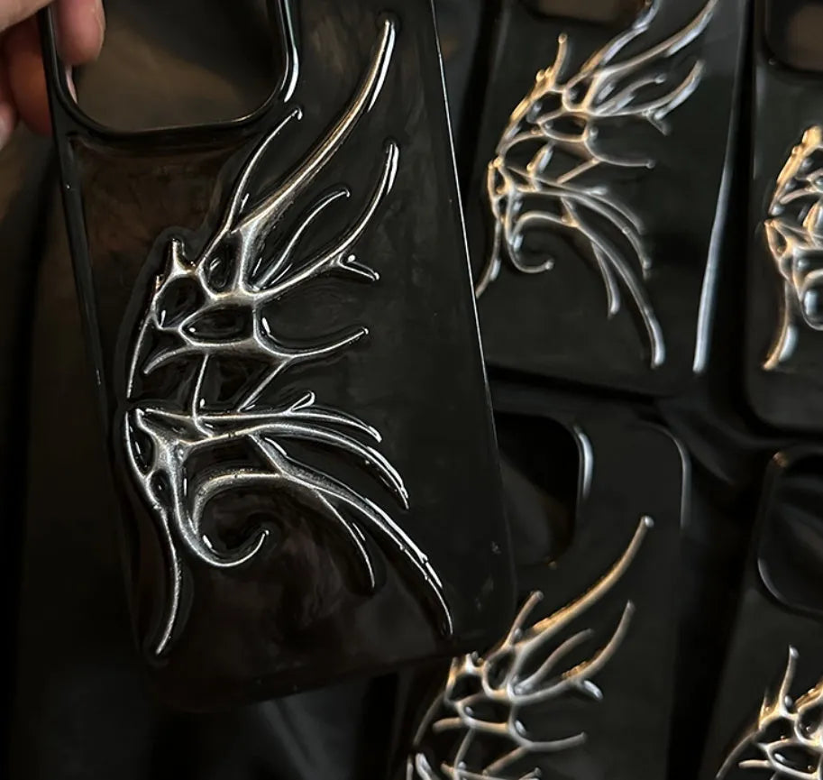 Black iPhone case with three-dimensional wings design showing textured surface