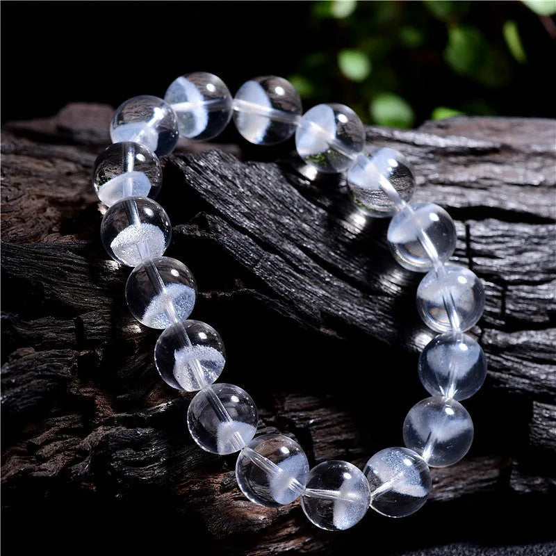 Women's white crystal ghost pyramid bracelet with Ruyi charm on a wrist, showing adjustable sizing.