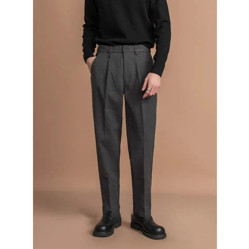 Men's straight-leg casual trousers in draped design, shown in a neutral colour on a hanger.