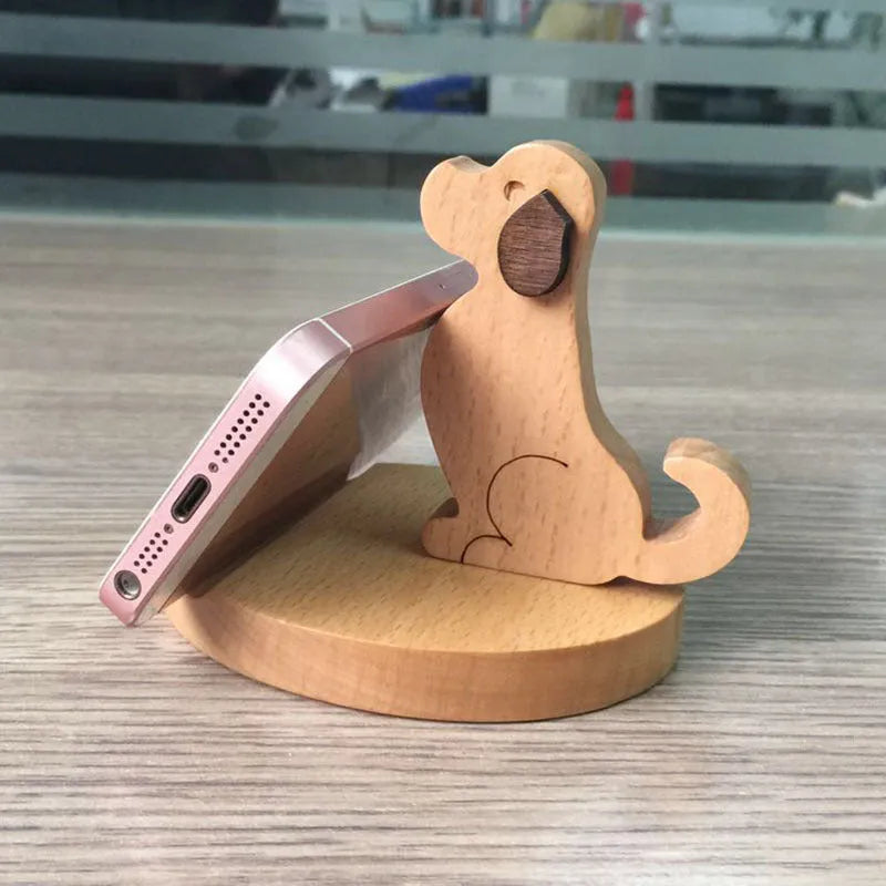 Beech wood and resin lazy bracket mobile phone holder in an animal design style on a desk.