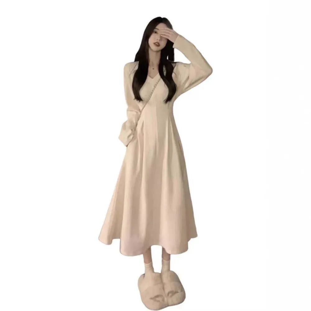 Women's white V-neck knitted dress with princess sleeves and a suspender skirt design.