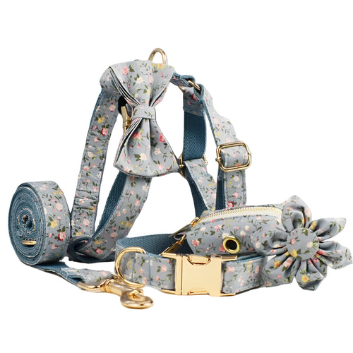 Blue floral patterned dog collar set with matching leash, bow, vest, and poop bag accessories