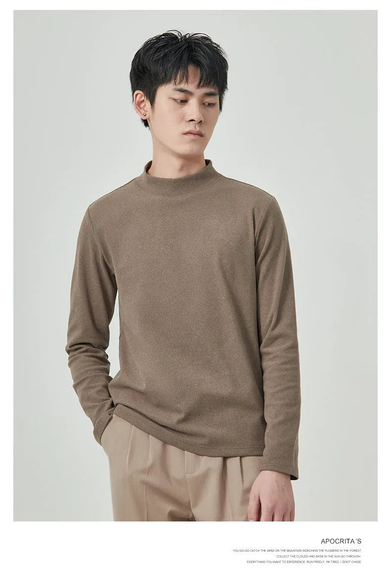 Men's brown Dralon fabric long sleeve t-shirt with a half-high collar on a hanger.