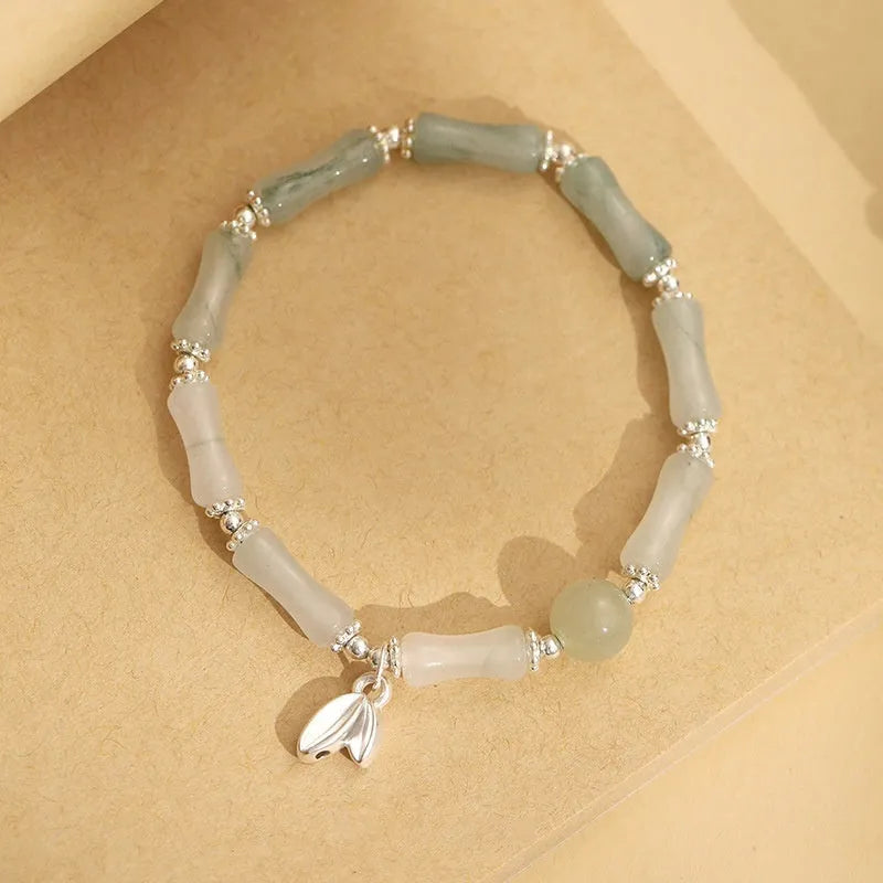 Natural Tianshan green bamboo and sterling silver antique-style bracelet for women with a bamboo joint motif.