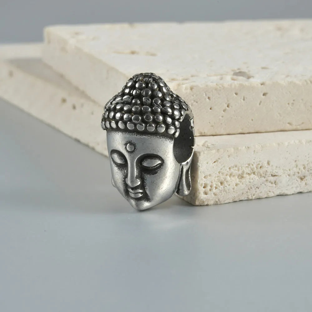 Stainless steel hollow skull Buddha earring in a geometry shape, shown in one of four colour options.