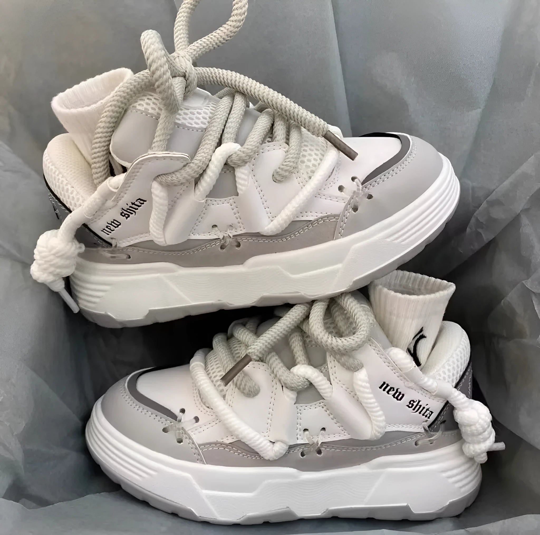 Grey women's retro clunky sneakers with thick rubber sole and lace-up front.