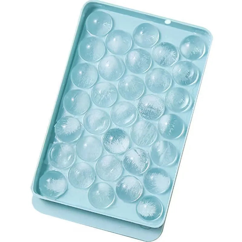 Blue round silicone ice cube tray with lid showing 33 mould cavities
