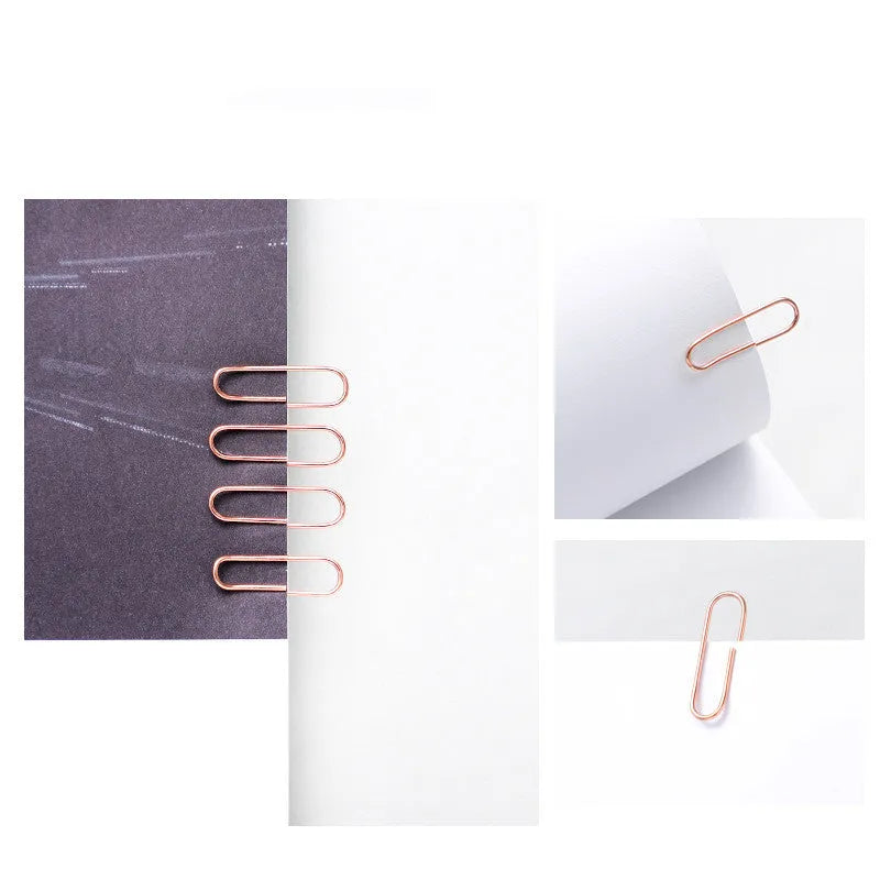 Rose gold coloured metal heart-shaped paper clips, size 28mm, in a box of 100 pieces.