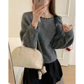 Women's loose-fitting knit pullover top in black, made from regenerated cellulose fibre, available in sizes L, M, S