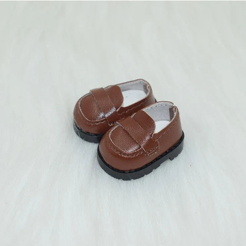 A pair of 17cm scale PU doll shoes in a selected colour and style, such as black leather shoes or brown boots.