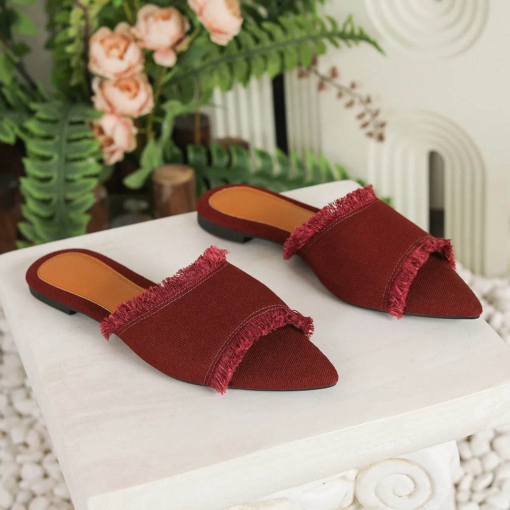 Women's apricot denim slippers with a tassel and leather lining on a lightweight PVC sole.