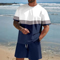 Man wearing a loose fit light blue short-sleeved t-shirt and matching shorts summer set.