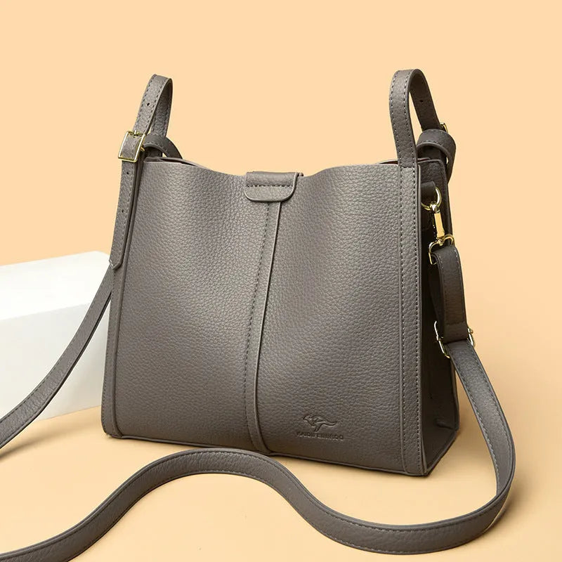 Brown retro ladies shoulder bag with zip compartments showing vertical square shape and single strap