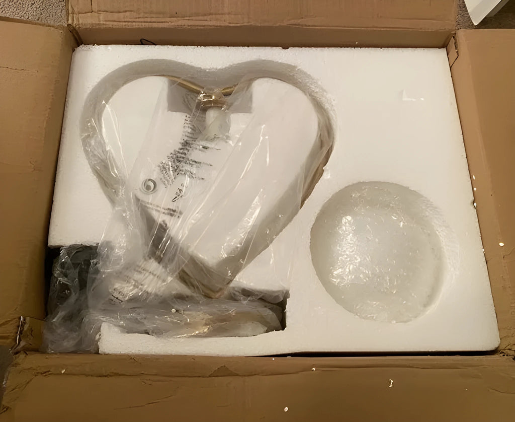 White heart shaped table lamp with fabric shade on wooden table
