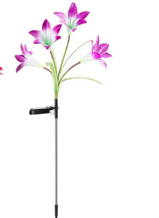 Solar lily flower light with silk cloth head, colour-changing LEDs, and stainless steel stake in a garden setting