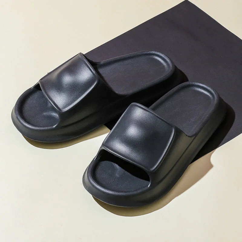 Pair of thick-soled EVA flip-flop slippers in a choice of seven colours, shown on a wet bathroom floor.