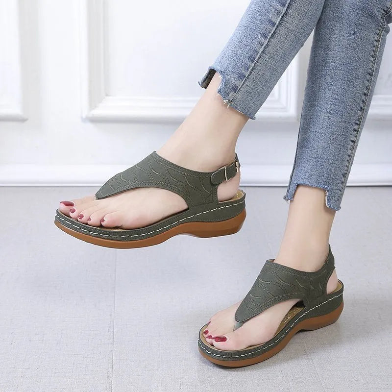 Women's solid colour wedge heel flip flop sandals with an adjustable buckle strap.