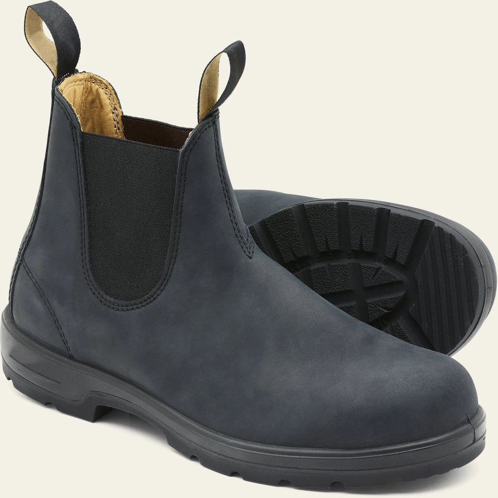Vintage frosted brown leather Chelsea boots with round toe and car suture detailing on a wooden floor.