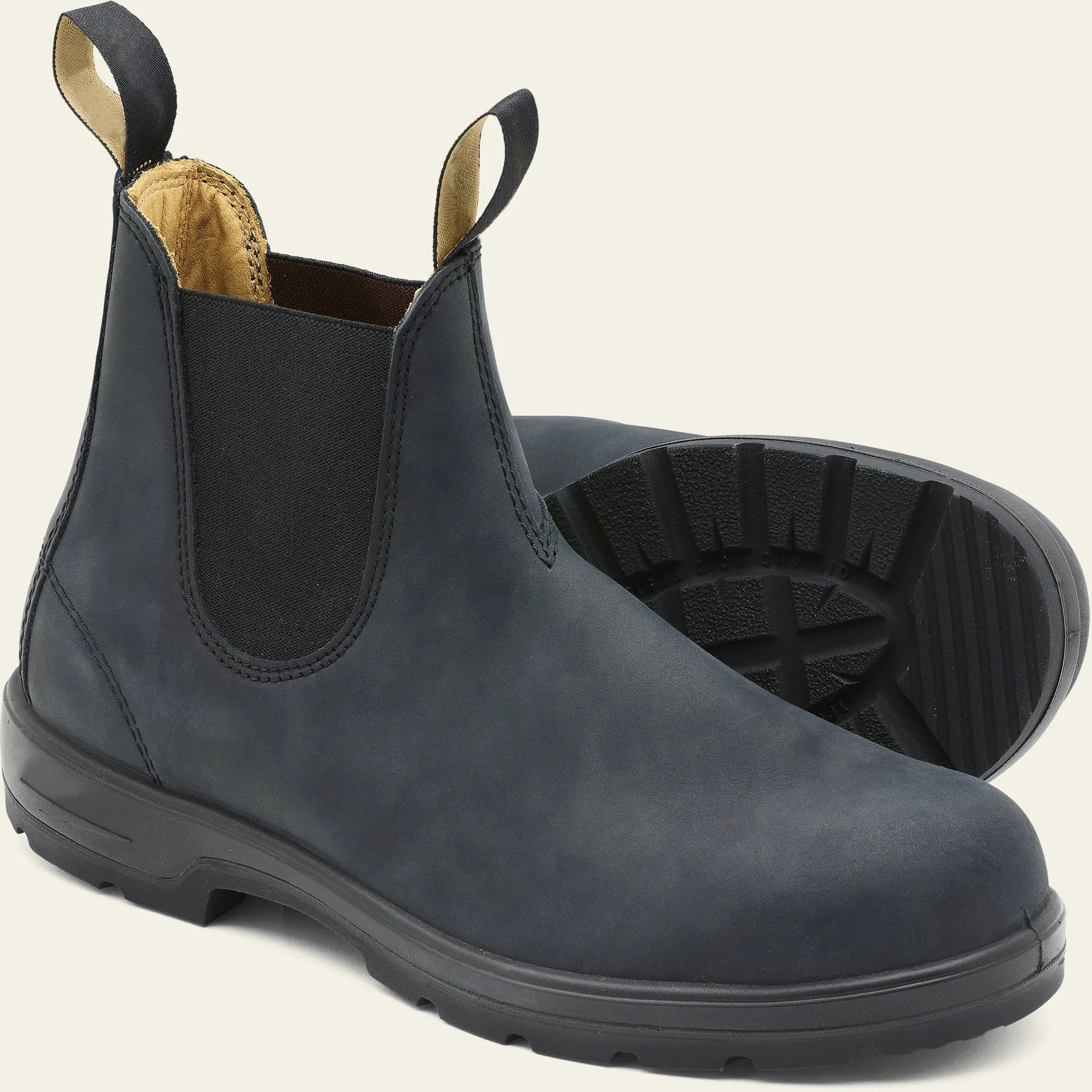 Vintage frosted brown leather Chelsea boots with round toe and car suture detailing on a wooden floor.
