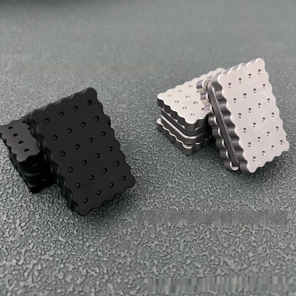 Biscuit silver 3-layer metal EDC fidget push card decompression toy on white background