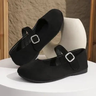 Black low-top canvas fisherman shoes with rubber sole on a white background