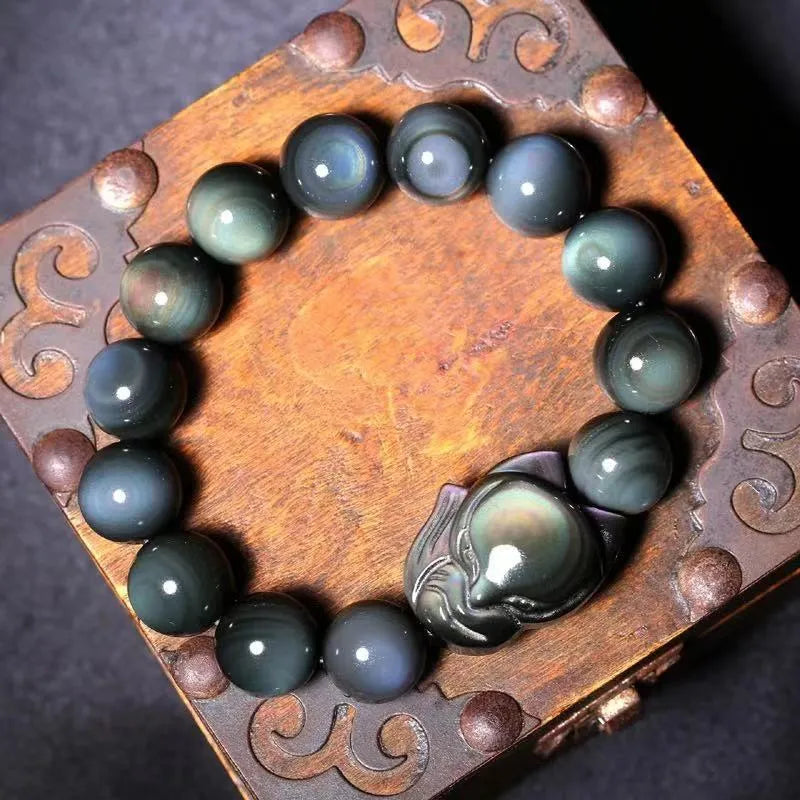 Obsidian stone bracelet with carved fox design in cartoon style, shown in various sizes