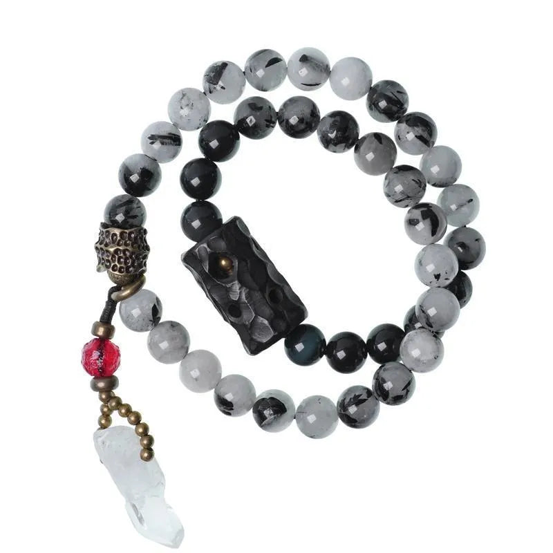 Ethnic black hair bracelet with white crystals and tassels showing bending lacing construction