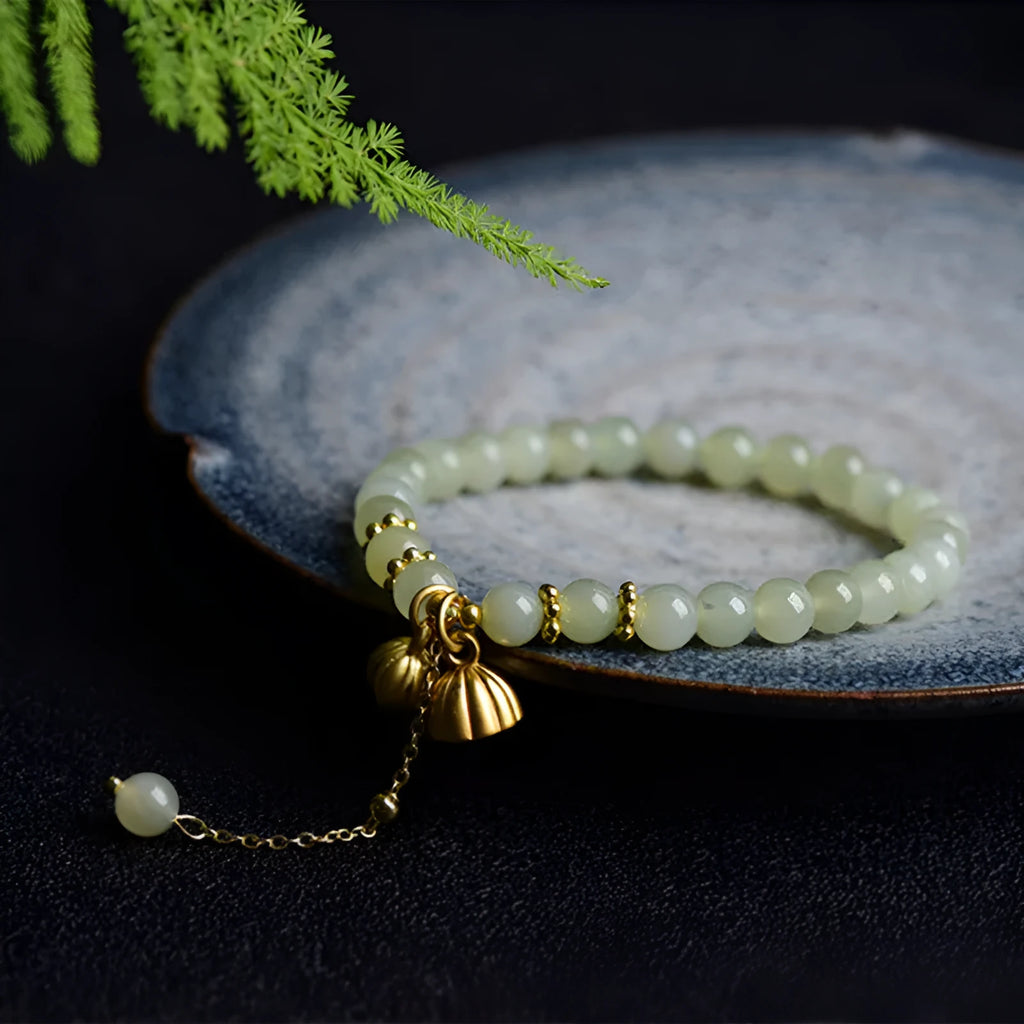 Natural Hetian Jade bracelet with six millimetre beads in step by step lotus pattern