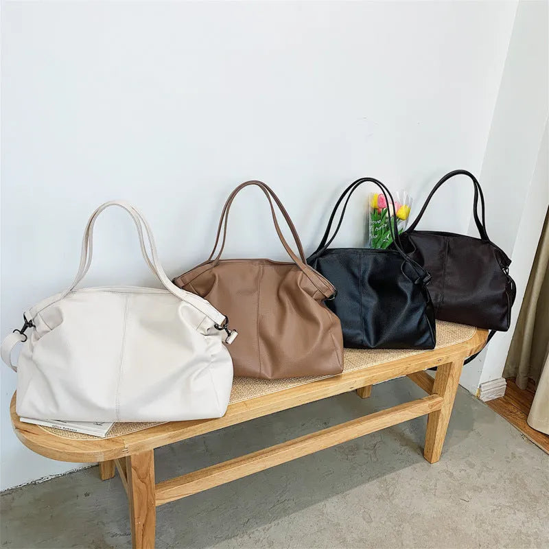 Soft surface messenger shoulder bag in horizontal square shape with zipper opening and internal compartments