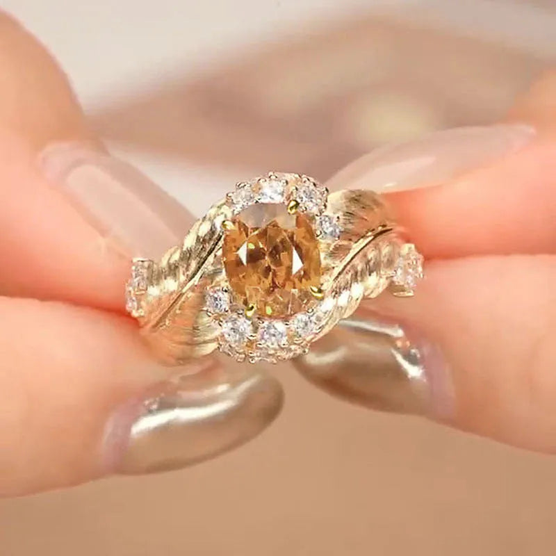 Women's gold-colour copper ring with embossed feather design and inlaid yellow zircon stones in geometric shape