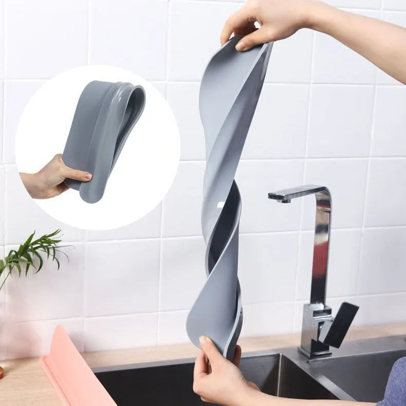 Black silicone kitchen sink water blocking plate measuring 52x5x85mm placed around faucet base