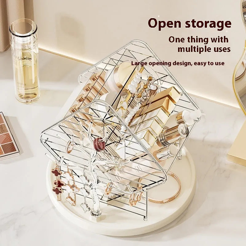 Rotating clear plastic cosmetics storage box with tiered compartments for brushes and bottles.
