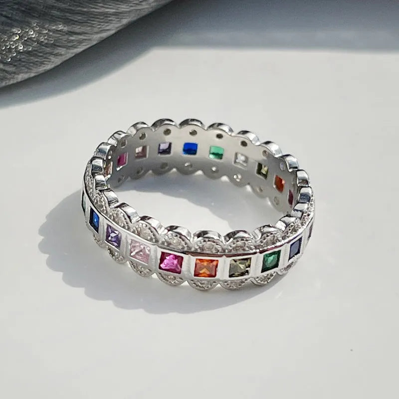 S925 sterling silver adjustable lace ring with rainbow zircon stones on a white background.