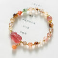 Copper women's bracelet with strawberry quartz crystal, Pixiu charm, and pearl accents on a white background.