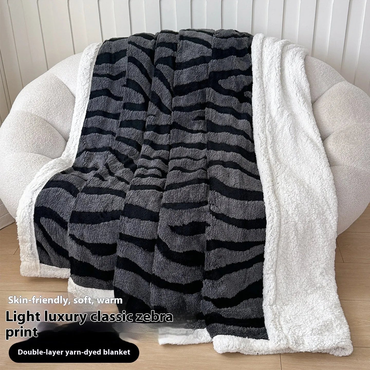 Double-layer taffeta blanket with woven leopard print pattern draped over sofa