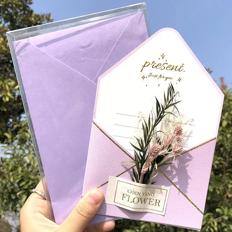 Handmade 3D butterfly-shaped greeting card with artificial flowers in a box, alongside its matching envelope.
