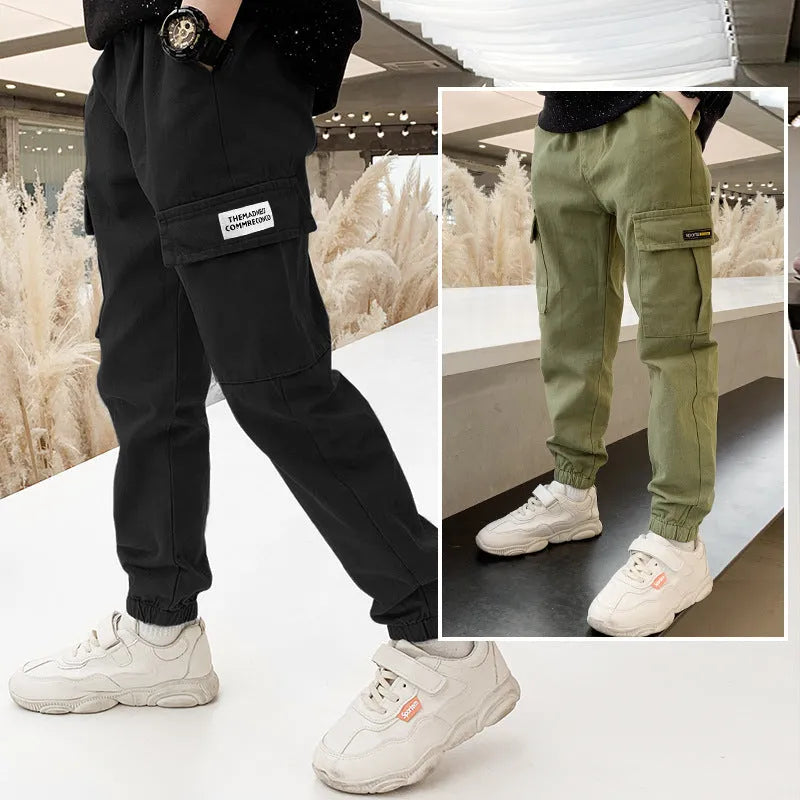 Boys' casual cotton summer trousers in army green, shown flat with size label visible.