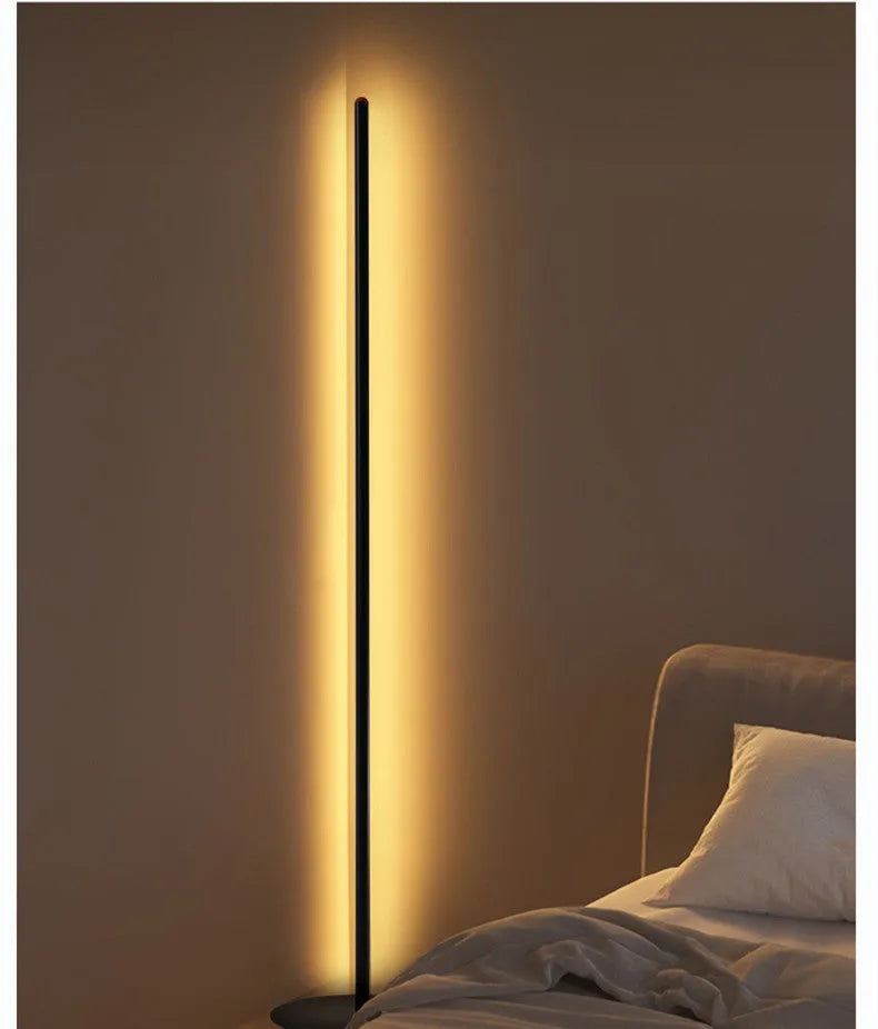 Vertical aluminium alloy floor lamp in modern simple style beside sofa