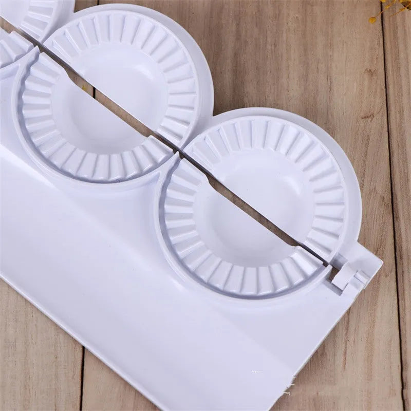 Pure white ABS plastic dumpling mould on a countertop, showing the mould shape for pressing dumplings