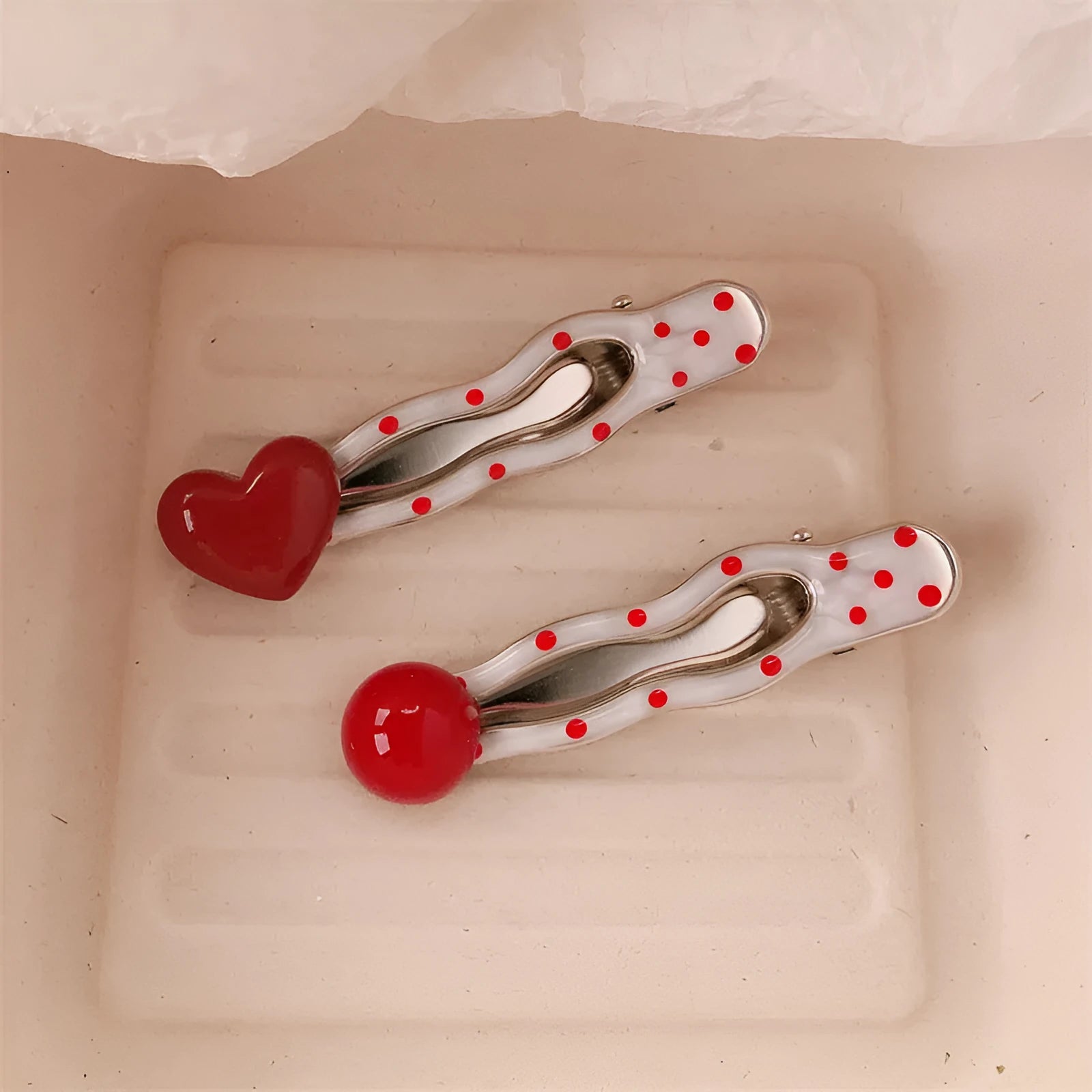 Red love heart-shaped plastic hair clip with retro dots and a willow leaf silhouette on a white background.